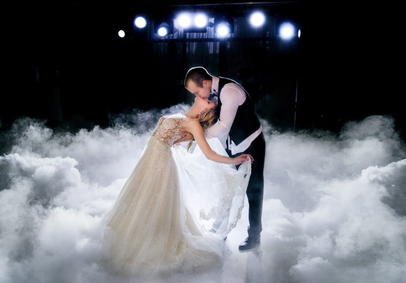 Couple performing move in smoke during first dance